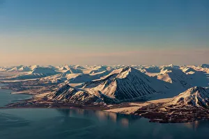 Longyearbyen Prints: Sunlight highlights ice covered mountains on Spitsbergen Island, Svalbard, Norway