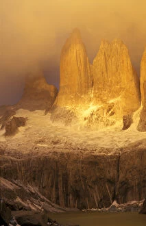 Sunrise with golden clouds on Torres del Paine in Patagonia region of Chile