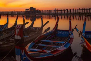 Burma Prints: Sunrise over the lake with fishermen on boats fishing in the lake near wooden footbridge