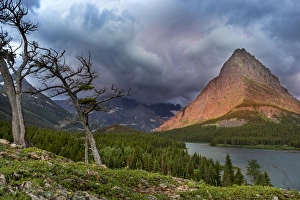 Grinnell Point Prints: Sunrise light strikes Grinnell Point over Swiftcurrent Lake in Glacier National Park