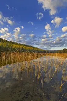 Sunrise lights clouds over Spencer Lake near Whitefish Montana