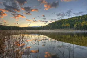 Sunrise lights clouds over Spencer Lake near Whitefish Montana