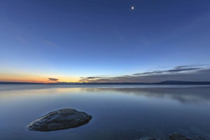 Ecosystem Prints: Sunrise and Moon setting over Yellowstone Lake. Yellowstone National Park. Wyoming