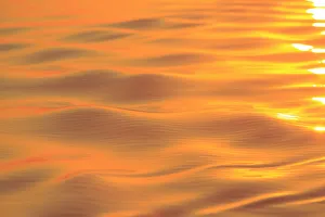 Images Dated 11th September 2013: Sunset colors and patterns on small waves in water