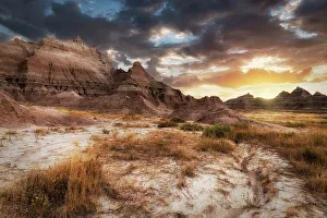 Sunset in dramatic skies over the hoodoo peaks of the Badlands