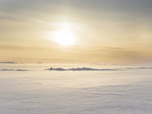 Greenland Collection: Sunset over the stormy and frozen Melville Bay, near Kullorsuaq in the far north of West
