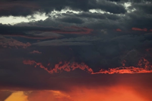Images Dated 19th January 2024: Sunset turns cumulus clouds bright red and orange