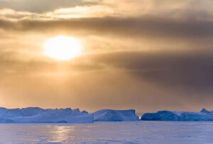 Sunset during winter at the Ilulissat Fjord, located in the Disko Bay in West Greenland
