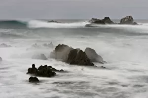 Surf crashing on the California coastline between large rocks