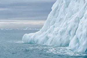 Svalbard, Nordaustlandet Island. Colorful bits of ice have calved from the glacier