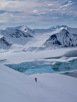 One Person Prints: Svalbard, Norway. Guide and skier enjoys a pristine slope