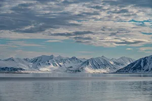 Images Dated 26th November 2023: Svalbard, Norway. Landscape of mountain, water and clouds