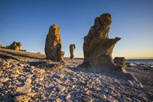 Sweden, Faro Island, Langhammars Area, Langhammar coastal limestone rauk rock, sunset