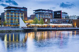 Europe Prints: Sweden, Lake Vattern Area, Jonkoping, renovated harbor area along Munksjon Bay, dusk