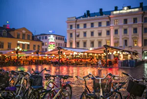 Europe Prints: Sweden, Linkoping, cafes and bars on Stora target square, dusk