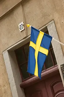 Cruise Port Prints: Sweden, Stockholm. Swedish flag over doorway in Gamla Stan (Old Town) Stockholm