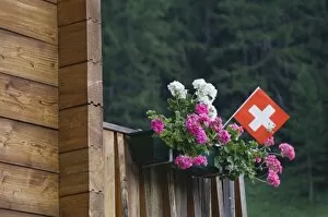 Swiss flag and flower pot, Binn, Wallis, Switzerland, August
