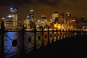 Sydney skyline at night with the Sydney Harbour in the foreground. Sydney. NSW. AUSTRALIA
