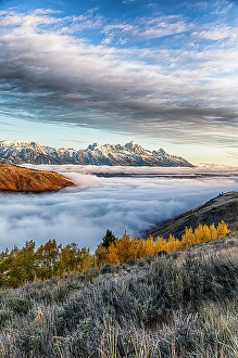 New Images March 2024 Part 1 Prints: A temperature inversion cause a layer of fog to form in the valley below the peaks of Grand Teton National Park