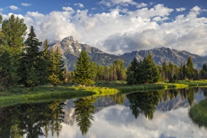Teton mountains relfect in Schwabacher Landing on the Snake River in Grand Teton National Park