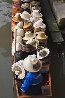 Images Dated 18th February 2006: Thai woman selling hats, Damnoen Saduak Floating Market, Damnoen Saduak, Thailand