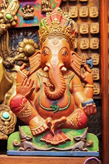 Deity Prints: Thailand, Bangkok. Carved and painted wooden statue of Ganesha, or Phra Phikanet