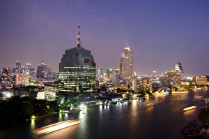 Images Dated 24th February 2012: Thailand, Bangkok. Downtown Bangkok, evening skyline view of the Chao Phraya river