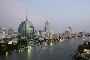 Images Dated 24th February 2012: Thailand, Bangkok. Downtown Bangkok, evening skyline view of the Chao Phraya river