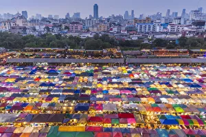 Cityscape Prints: Thailand, Bangkok. Royal City Avenue, Talat Rot Fai 2 outdoor market at dusk