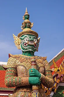 Thailand, Bangkok. Yaksha, demon depicted in the Ramayana, guarding Wat Phra Kaew (Temple of The Emerald Buddha)