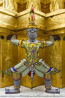 Thailand, Bangkok.Yaksha (demons) guard one of the golden chedi at Wat Phra Kaew