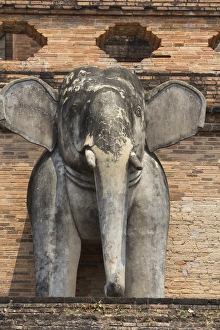 Thailand, Chiang Mai, Wat Chedi Luang. Elephant statues around temple exterior