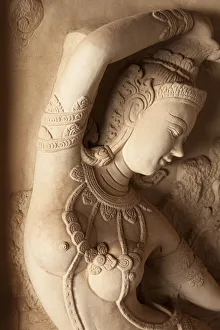 Thailand, Ko Samui. Carved stone relief of a Hindu deity