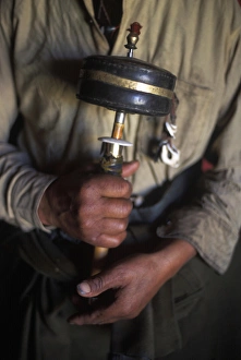 Holding Prints: Tibet, Kham Tibetan man with prayer wheel, Kandze