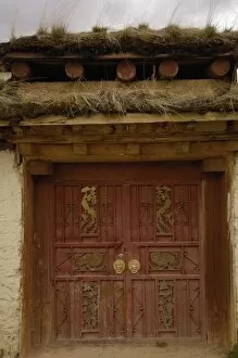 Tibetan house door ornately carved. Zhongdian. Deqin Tibetan Autonymous Prefecture