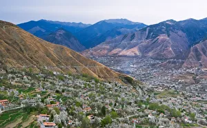 Prints of Tibetan village houses with farmland and pear tree blossoms in the valley, Jinchuan, Sichuan Province, China Images Dated 2016 December: Tibetan village houses with farmland and pear tree blossoms in the valley, Jinchuan