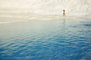 Travertine Prints: Tourist on travertine terraces of Pamukkale, Turkey (UNESCO World Heritage Site)