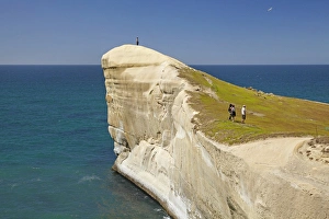 Dunedin Prints: Tourists on cliff top at Tunnel Beach, Dunedin, South Island, New Zealand