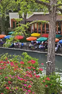 Residential Housing Prints: Tourists dining in outdoor cafe under colorful umbrellas on the famous River Walk