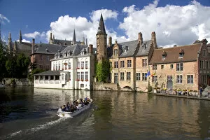Tourists ride in a canal boat at the city of Bruges in the province of West Flanders