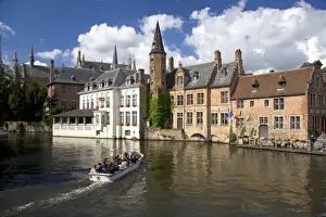 Brugge Prints: Tourists ride in a canal boat at the city of Bruges in the province of West Flanders