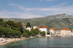 Images Dated 8th July 2006: Tourists with the village and Mount Sveti Ilija mountain. Orebic town, holiday resort