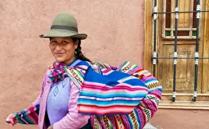 Images Dated 2028: Traditional woman in dress and hat with baby on back in small town of Pisaq Peru