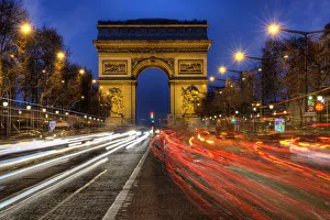 Traffic Prints: Traffic passes the Arch de Triumph on the Champs Elysee in Paris, France