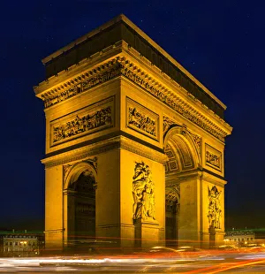 Traffic passes the Arch de Triumph on the Champs Elysee in Paris, France