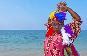 Images Dated 2029: Trinidad Cuba dancers in costume on beautiful beach of ocean with blue water