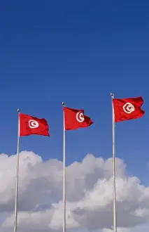 Blowing Prints: Three Tunisia national flags flting at Tunis Airport in Northern Africa