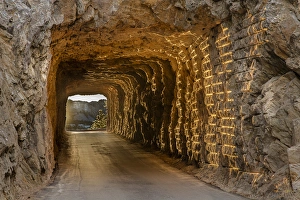 Great Plain Prints: Tunnel on Iron Mountain Road lit by setting sun with view of Mount Rushmore near Keystone
