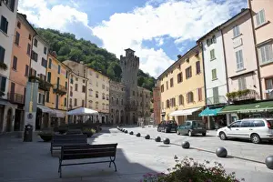 Infrastructure Prints: Tuscany, Italy - A pedestrian plaza with park benches amongst city town buildings