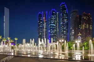 Asia Gallery: UAE, Abu Dhabi, Emirates Palace Hotel fountains and Etihad Towers, dusk